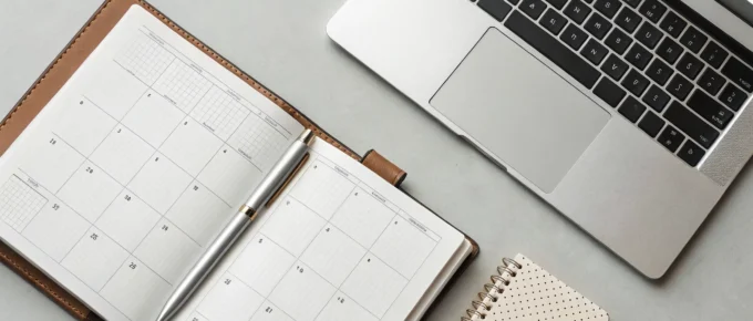 Planner and laptop organized for how to renew a CDA credential.